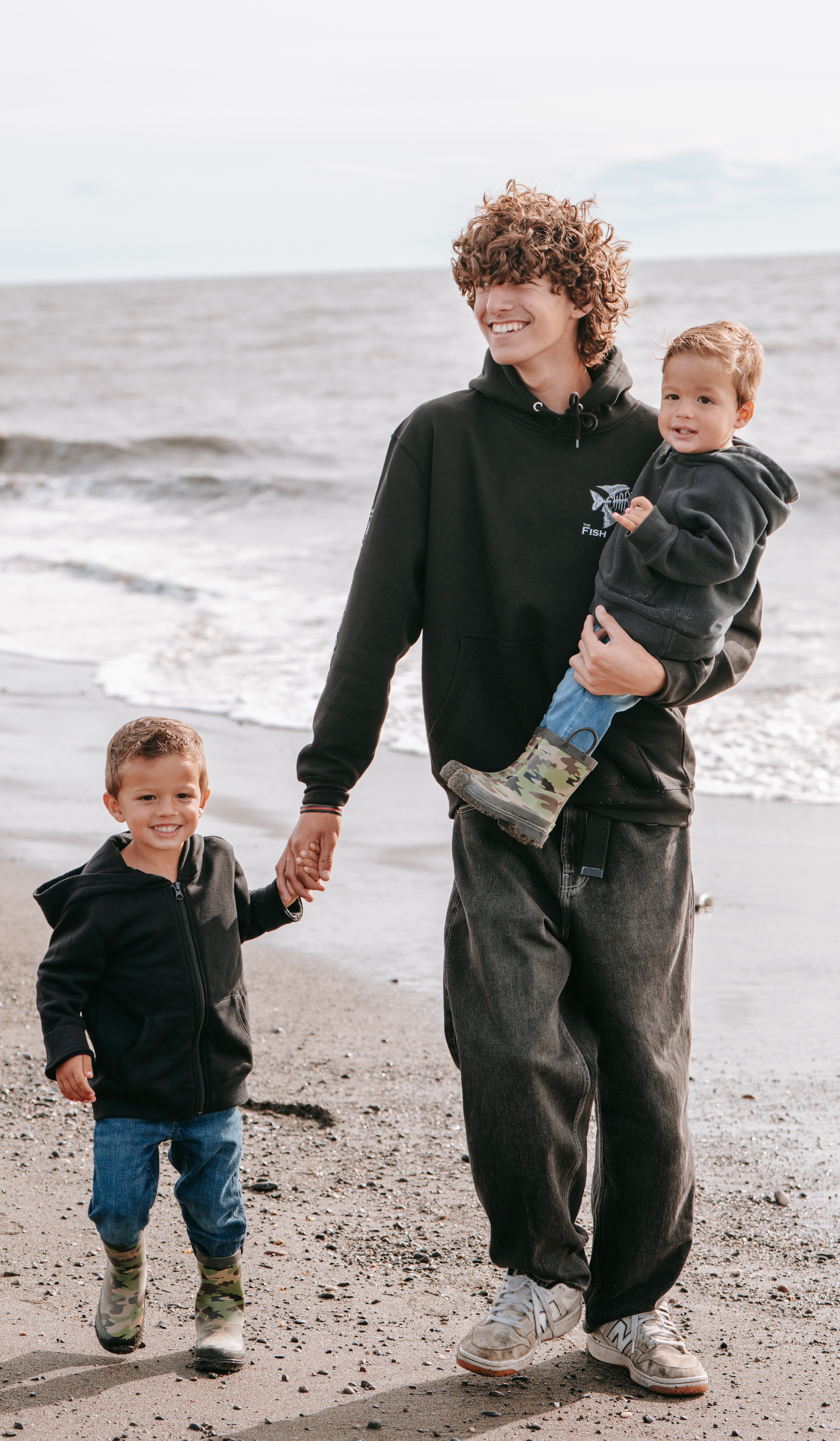 Maximus with younger siblings on the beach