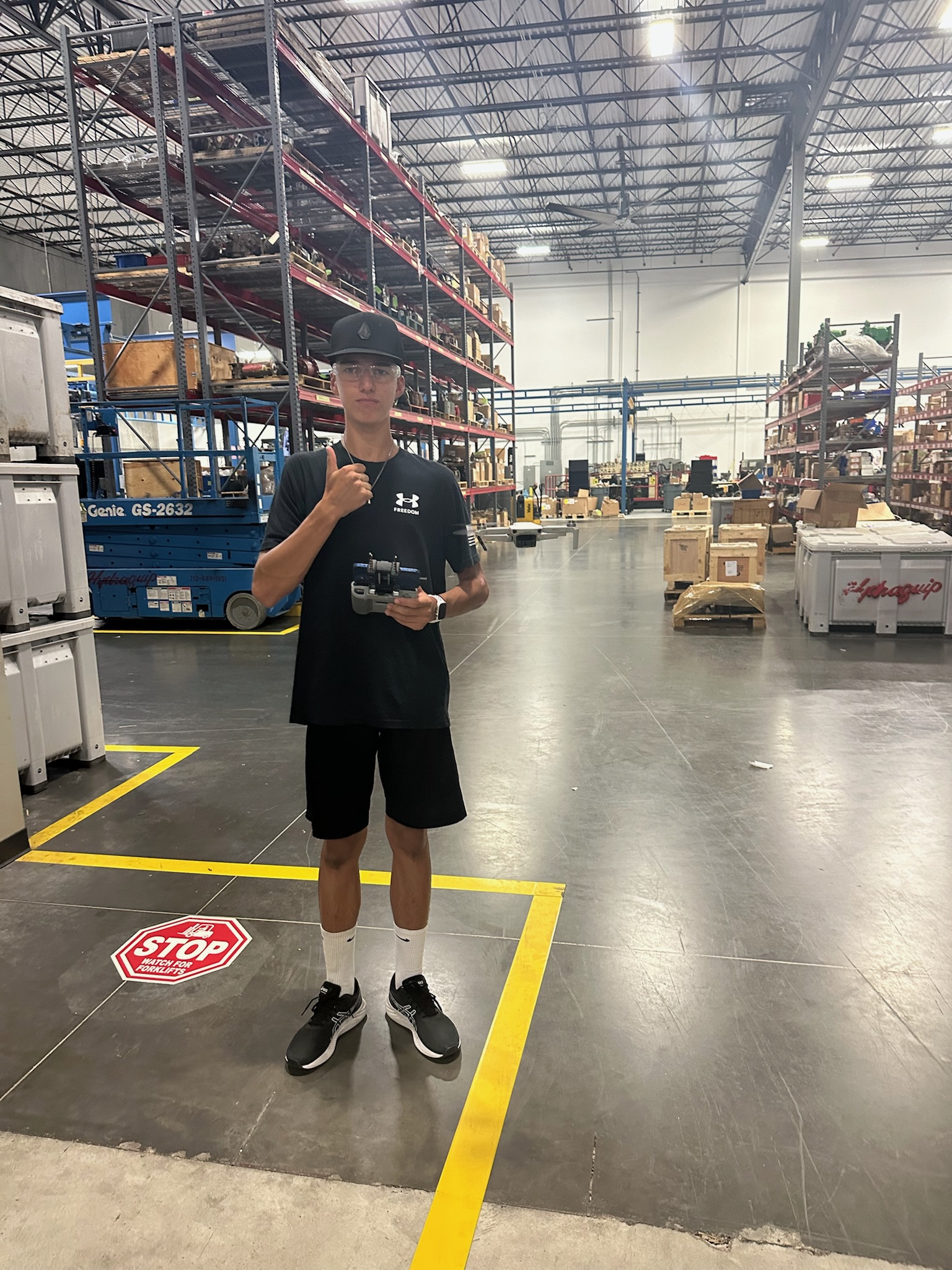 Maximus with his drone in a warehouse
