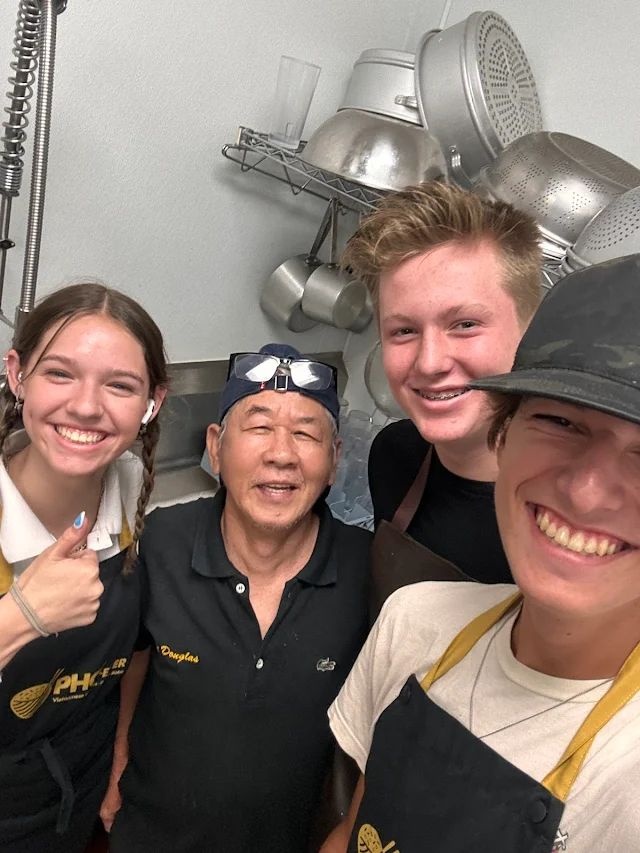 Maximus working at the Pho restaurant